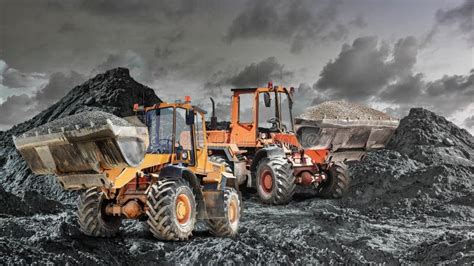 Two Loaders or Bulldozers Move Gravel in a Quarry. Powerful Wheel ...