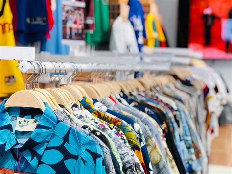 shirts hanging on racks in a clothing store