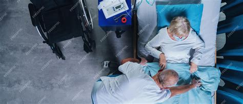 Premium Photo | A top view of doctor putting covid-19 patient in bed in hospital, coronavirus ...