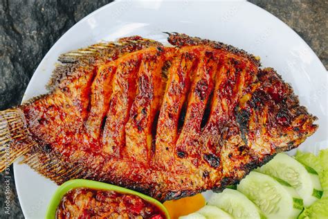 Delicious grilled tilapia (nila bakar) from indonesia with rice, tempeh ...