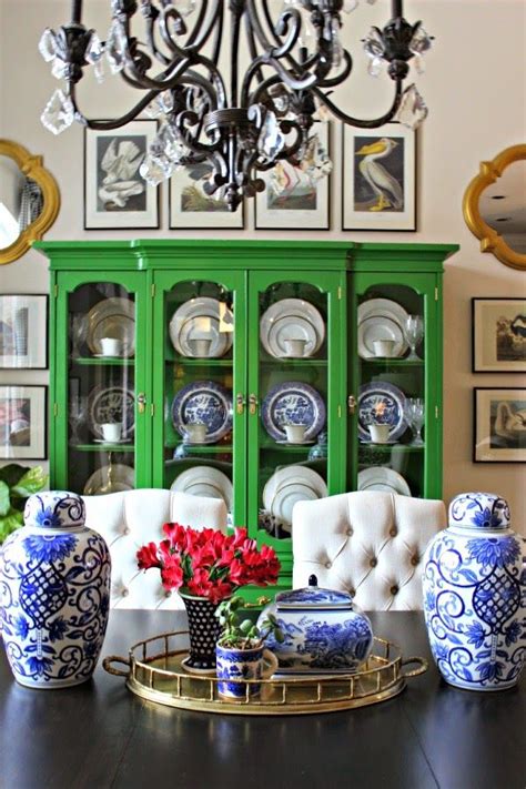 a dining room table with blue and white vases