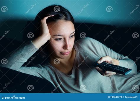 Young Woman Watching Television Alone at Night on the Couch Stock Photo ...