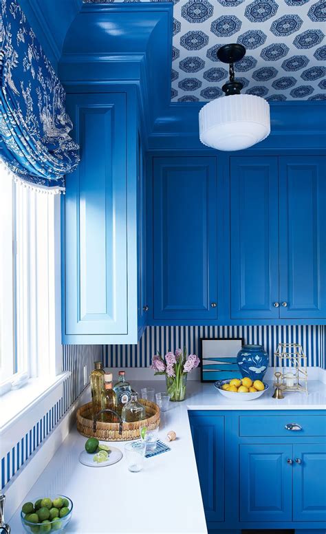 a kitchen with blue cabinets and white counter tops