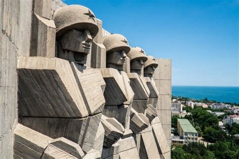 brutalist design of a monument, featuring four soldiers, with helmets ...