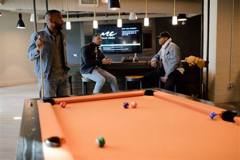 Man Playing Pool Table While Sharply Looking at the White Ball on the ...