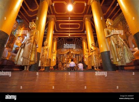 Two devotees inside Buddhist temple Shwedagon Pagoda Yangon Myanmar ...