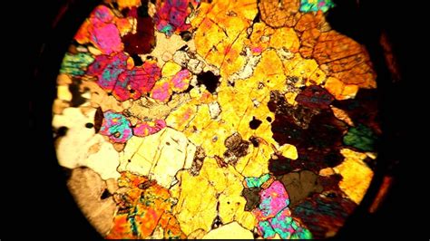 A thin section viewed through a petrographic microscope with stage rotation - YouTube