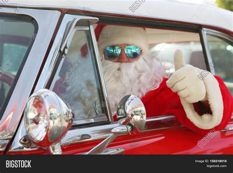 Santa Claus drives his Hot Rod Car. Santa Drives his car. Santa Claus arrives in style. Santa ...