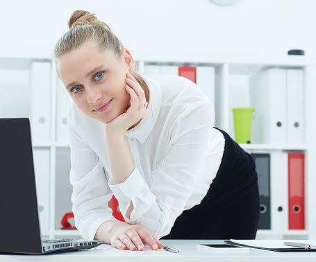 Portrait Of A Young Female Secretary Standing Next To A Table With A Laptop Stock Photo ...