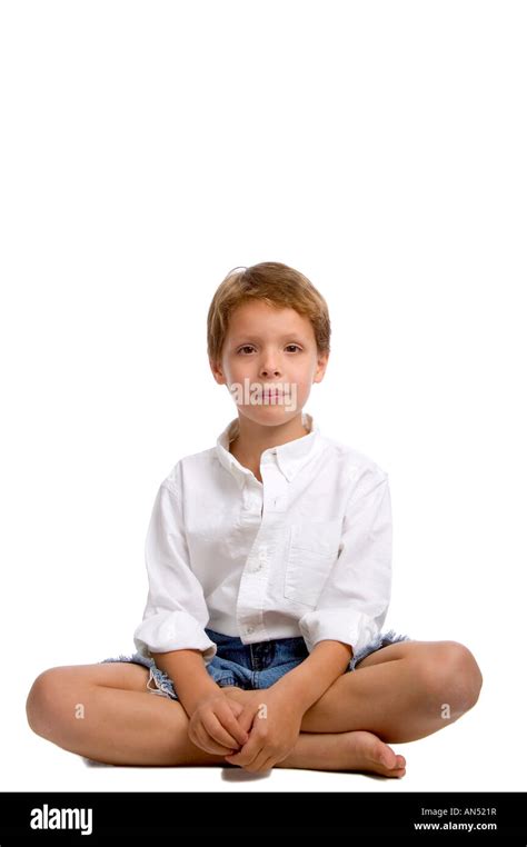 a boy sitting cross legged Stock Photo - Alamy