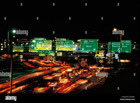 Freeway interchange signs and heavy traffic At Night Dallas Texas Stock Photo - Alamy