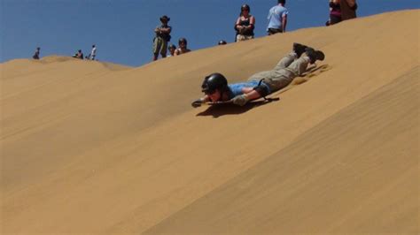 Surfing the world's highest sand dunes straight into the ocean in ...