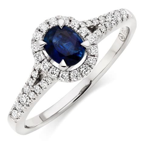 an oval shaped blue sapphire and diamond halo ring with two rows of ...