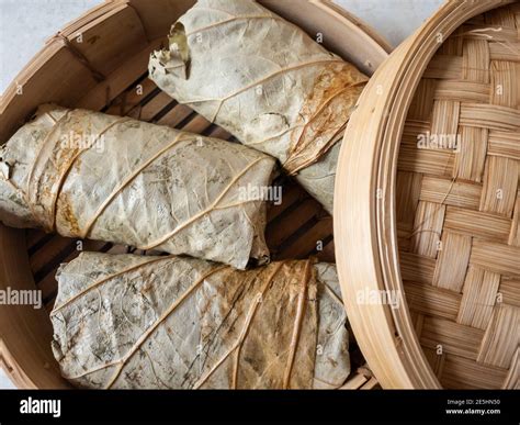 Sticky rice wrapped in lotus leaf ready for steaming Stock Photo - Alamy