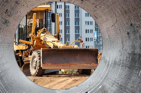 Premium Photo | Road grader for land leveling at a construction site ...