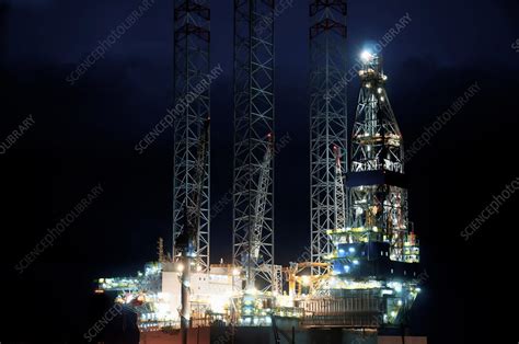 Oil rig at night - Stock Image - F017/8160 - Science Photo Library