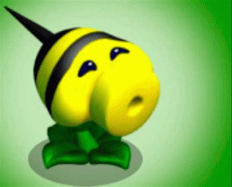 a yellow and black toy with horns on it's head sitting on a green surface