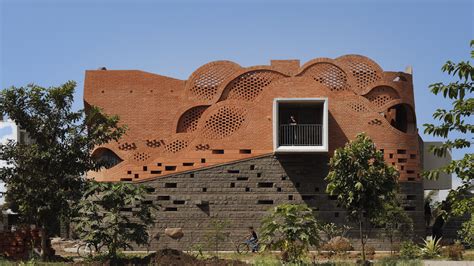 PMA Madhushala wraps Indian home in perforated wall of brick and stone ...