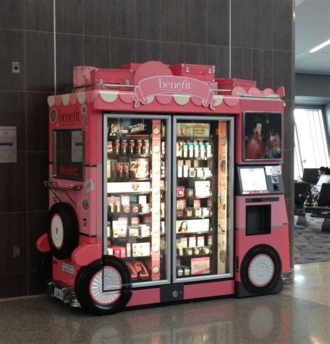 a pink vending machine sitting inside of an airport