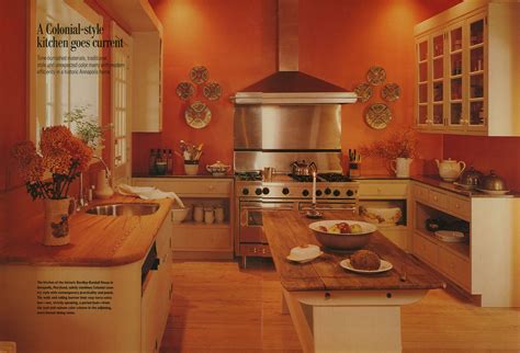 Kitchen with orange walls, cream cabinets and wooden counters - Home ...