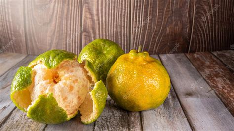 Premium Photo | Ponkan oranges photographed on rustic wood selective focus