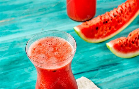 Premium Photo | Watermelon juice in cup, watermelon sliced and bottle over blue wood and stone ...