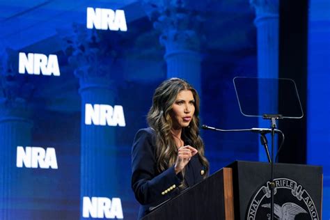 Gov. Kristi Noem signs executive order during NRA Convention