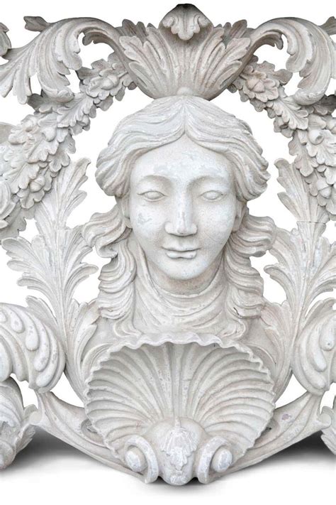 a white sculpture with an ornate frame around it