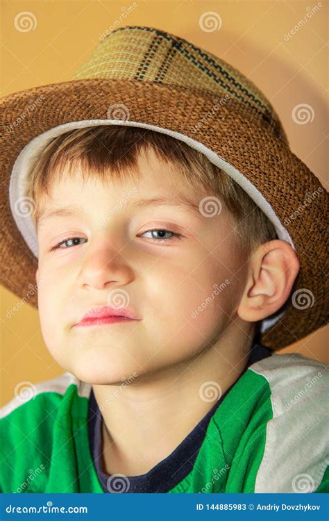 A Proud and Greedy Boy in a Straw Hat with a Haughty Facial Expression ...