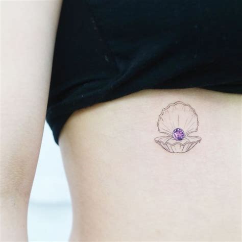 Small sea shell with pearl gem tattoo on ribcage | Minimalist tattoo, Seashell tattoos, Pearl tattoo