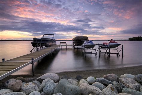 Boat dock at sunset with raised boats and jet ski's - Heritage Title