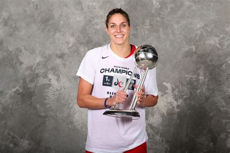 WNBA MVP poses with the WNBA Finals trophy.