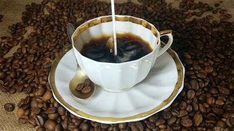 Pouring Milk Into The Cup Of Fresh Brewed Coffee In Slow Motion Stock ...