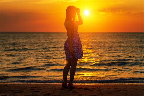 Premium Photo | Silhouette at sunset girl on the beach, evening walks ...