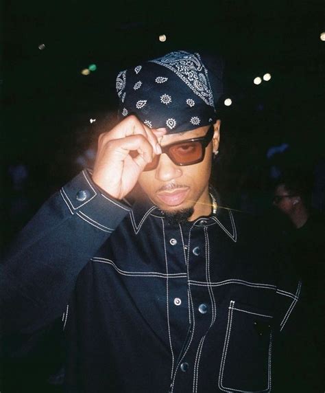 a man wearing sunglasses and a bandana on his head