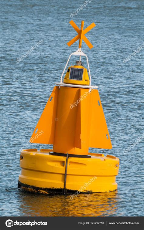 A yellow buoy floating on the water surface — Stock Photo © Catstyecam ...