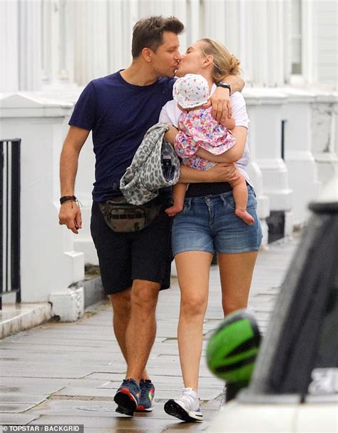 Rachel Riley and Pasha Kovalev kiss and cuddle as they take baby daughter Maven for a family ...