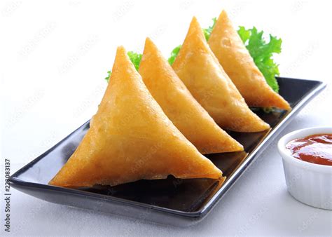 Samosa, Sambusa, Samboksa with a savory filling of chicken, mince, potato & vegetables Stock ...