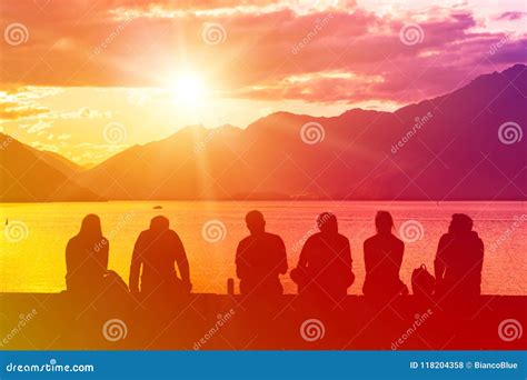 Silhouette Group of Young People Sitting on Beach Stock Photo - Image ...