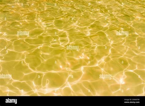 Gold swimming pool rippled water texture reflection Stock Photo - Alamy