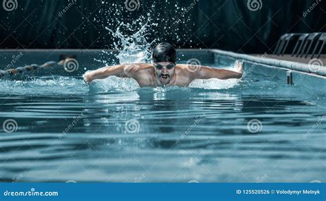 Dynamic and Fit Swimmer in Cap Breathing Performing the Butterfly ...