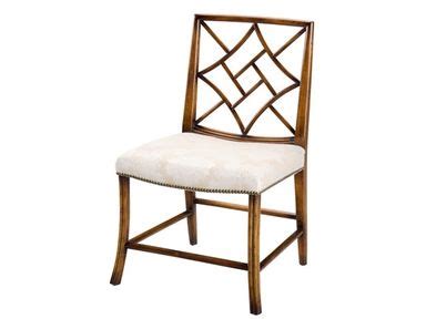 an upholstered wooden chair with white fabric