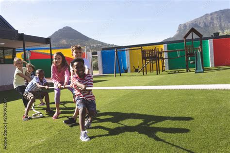 Group of school kids playing tug of war Stock Photo | Adobe Stock