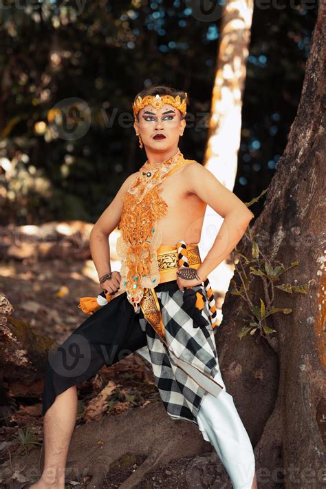 Balinese dancer performs the dance in golden costume and golden crown ...