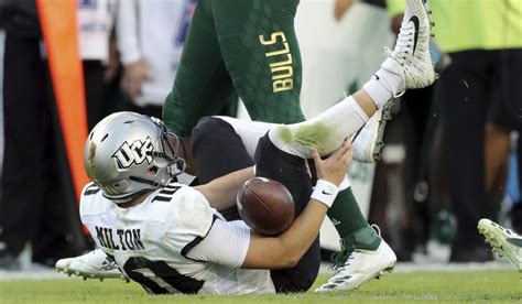 Central Florida quarterback McKenzie Milton goes down with an apparent knee injury after being ...