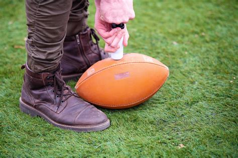 man pumping air into american football ball 12754140 Stock Photo at ...