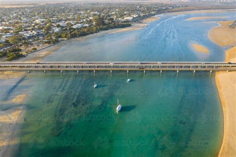 Image of Aerial view of bridges across a river mouth around a coastal ...