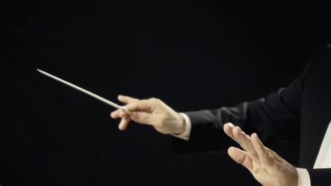 The Hands Of An Orchestra Conductor Directing The Musicians. Close-up ...