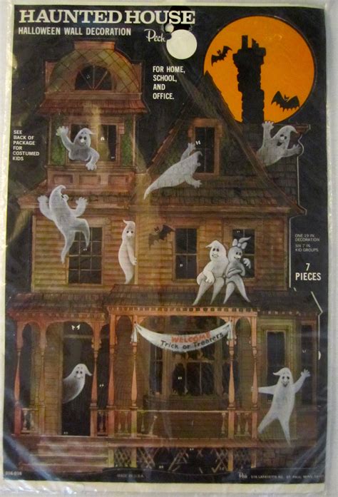 an old house decorated for halloween with spooky ghost decorations