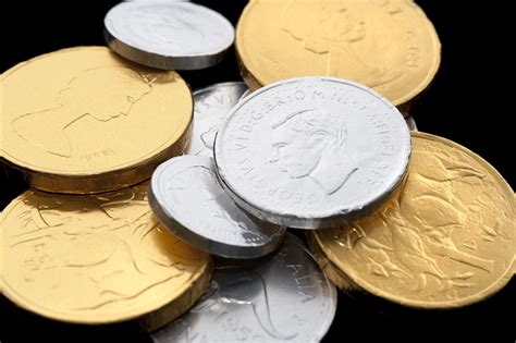 Photo of Chocolate coins wrapped in golden and silver paper | Free ...